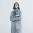 Model wearing a striped scarf in gray and blue, easy for weekend styling and gifting.