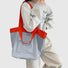 Model carrying a blue duotone foldable nylon tote as shoulder bag, easy for commuting and weekends.