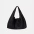 Essential black ease suede hobo bag showcasing its clean and flexible drape.