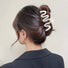 Model wearing Elegant Wave Hair Claw in cream, easy for workdays and special occasions.