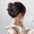 Model wearing Elegant Wave Hair Claw in dark khaki, ideal for quick updos and ponytails.