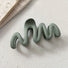 Folded view of Elegant Wave Hair Claw in green, ideal for quick updos and ponytails.