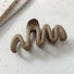 Close-up of Elegant Wave Hair Claw in light brown, easy for workdays and special occasions.