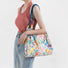 White polyester Floral Bloom Tote Bag with colorful flowers and blue rope straps.