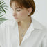 Model wearing a silver Fluid Shaped Pendant Necklace, easy for gifting and photo-ready styling.
