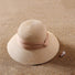 Front view of beige Ribbon Straw Hat. Timeless neutral tone with a premium woven texture and elegant bow.