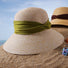 Front view of green Ribbon Straw Hat, showcasing fine-woven construction and a sophisticated ribbon tie.