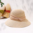 Foldable elegant straw hat with a wide brim and beige ribbon band for sophisticated summer sun protection.