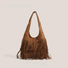 Tan vegan suede hobo bag with bohemian fringe detailing and a soft slouchy silhouette.