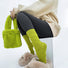 Model wearing Fuzzy embossed socks in vibrant lime green with a diamond pattern, paired with a matching fluffy.