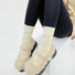 Model wearing a pair of Fuzzy Embossed Socks in white, ideal for workouts and commuting.