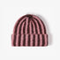 Brown and coral contrast striped fuzzy beanie with a soft knit texture.