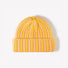 Close-up of the yellow and pink striped beanie showcasing the fuzzy texture.