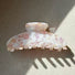 Folded view of Gentle Curve hair claw in rose shell , ideal for quick updos and ponytails.