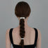 Model wearing two silver Gleaming Curve Hair Cuffs, ideal for quick updos and ponytails.