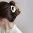 Model wearing a Glossy Cloud Hair Claw in pure white, ideal for quick updos and ponytails.