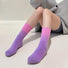 Model wearing a pair of Gradient Rainbow Socks in pink-to-purple, easy for travel days and daily comfort.
