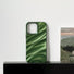Detailed wavy texture on green satin pleated silicone case. Elegant high-fashion phone accessory.