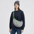 Model wearing a grey nylon crescent sling bag with a vibrant lime green knotted strap for a minimalist aesthetic.