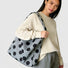 Grey vegan suede bag with black polka dots, perfect for a modern casual outfit.