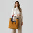 Front view of the plush corduroy tote used as a top-handle bag, highlighting the handcrafted rope hand.