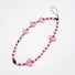 Close-up of Heart Beat Phone Charm with pink hearts and striped bead.