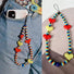 Close-up of Heart Beat Phone Charm in red, easy to attach to bags and phones.