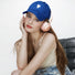 Klein blue cotton cap with white heart embroidery shown on a model.