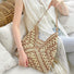 Model carrying a khaki Holiday Style Straw Tote Bag, great for everyday carry and travel.