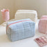 Close-up of Icecream Makeup Bag in blue, easy to pack for trips and daily use.