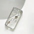 Clear silicone iPhone case with an irregular silver metal chain strap. Edgy portability fashion.