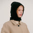 Classic black knitted balaclava being worn by a model in a neutral coat.