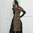 Model wearing long, wool blend leopard print knit scarf in brown and black, great for office layering and commuting.