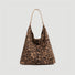 Front view of the bold leopard print suede hobo bag with a spacious interior.