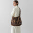 Model carrying the oversized leopard print tote bag as a crossbody bag.