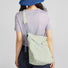 Rear view of a model carrying the lightweight casual bag, perfect for outdoor ease and city rhythms.