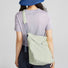 Rear view of a model carrying the lightweight casual bag, perfect for outdoor ease and city rhythms.