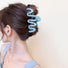 Model wearing Macaron Wave Hair Claw in blue, easy for workdays and special occasions.