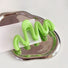 Flat lay of Macaron Wave Hair Claw in green, great for everyday styling and gifting.