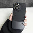 Black metal and PU leather case for iPhone with gold camera accents. Cyber-chic industrial style.