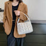 Model carrying a white polyester bag on the shoulder, ideal for city walks and gifting.