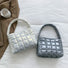 Folded view of Metallic Glow Quilted Bag in white and gray, easy for commuting and weekends.