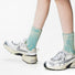Model wearing a pair of Metallic Tie Dye Slouch Socks, ideal for workouts and commuting.