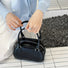Model handing Mini Leather Bowling Bag, great for daily carry and travel.