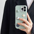 Model holding Mint Jewel Leather Case. Refreshing mint-green texture with subtle artistic embellishments.