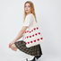 Model carrying the white heart crochet knit tote bag, styling a Coquette outfit.