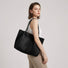 Classic Black Vegan Suede Tote carried by model - Effortless minimalist style for work or travel.