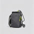 Studio flat lay of the dark grey multi-way nylon bottle carrier featuring its front zippered phone compartment.