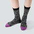 Model wearing a pair of Mystic Floral Socks, easy to pack for travel and errands.
