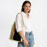 Model showcasing the neutral beige and brown woven crochet bag over her shoulder against a minimalist white background.
